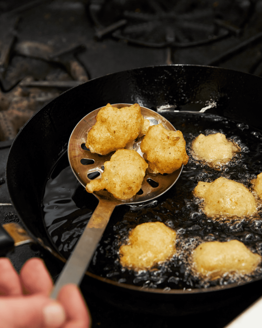 Fritelle di baccala in a pan with oil