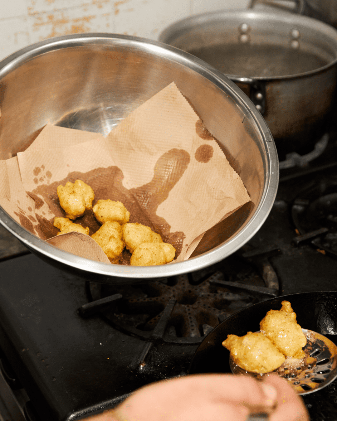 Fritelle di baccala in a tin bowl with paper towel